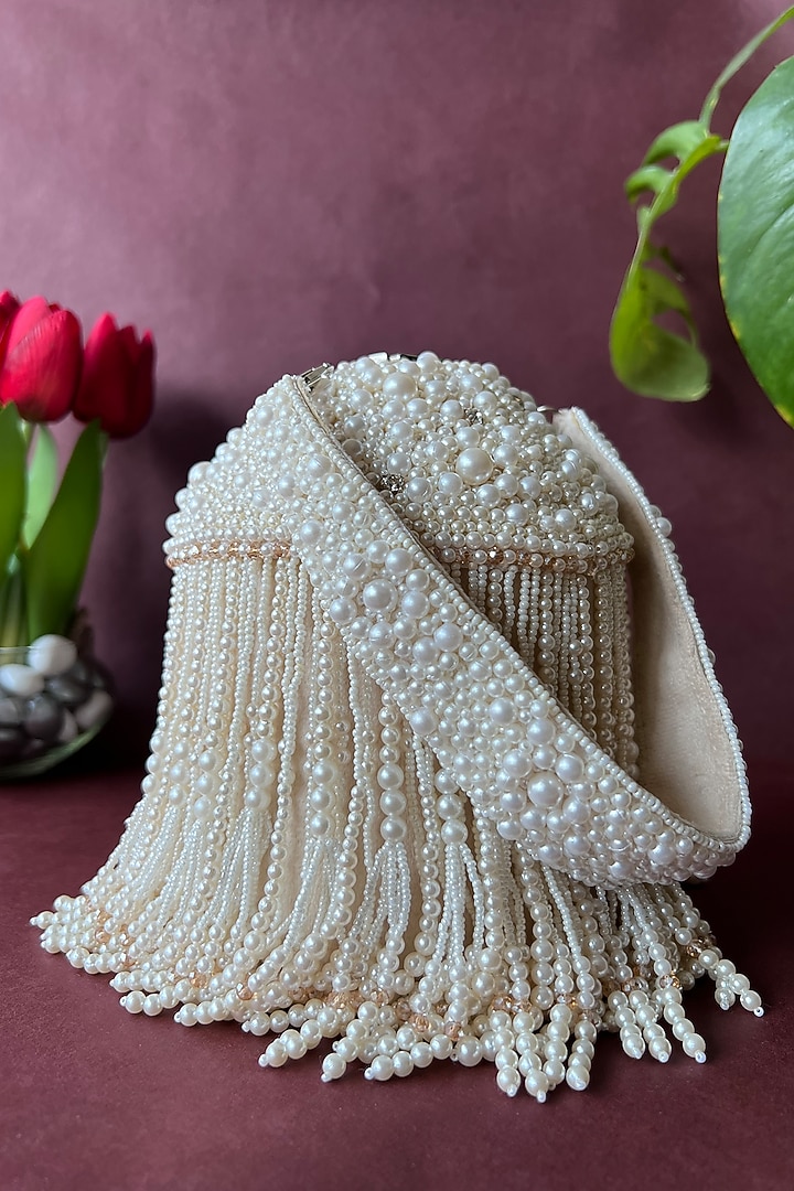 Off-White Suede Embroidered Potli by Nayaab by Sonia at Pernia's Pop Up Shop