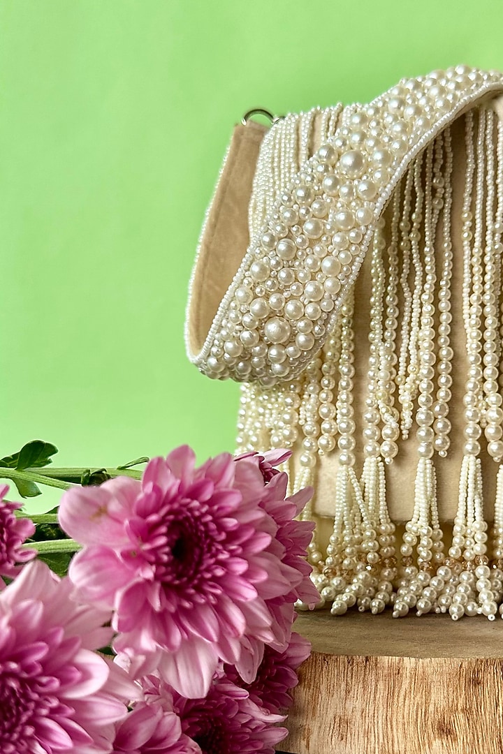 Ivory Suede Pearl Tassel Embroidered Potli by Nayaab by Sonia at Pernia's Pop Up Shop