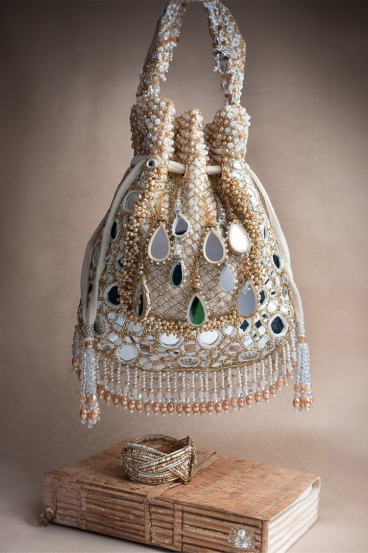 Ivory Silk Mirror Embroidered Potli Bag by Nayaab by Sonia at Pernia's Pop Up Shop