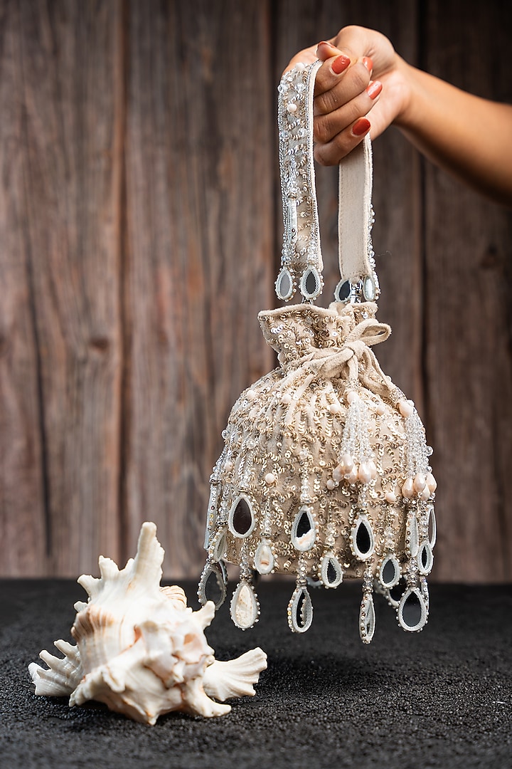 Off-White Silk Mirror Work Potli by Nayaab by Sonia at Pernia's Pop Up Shop