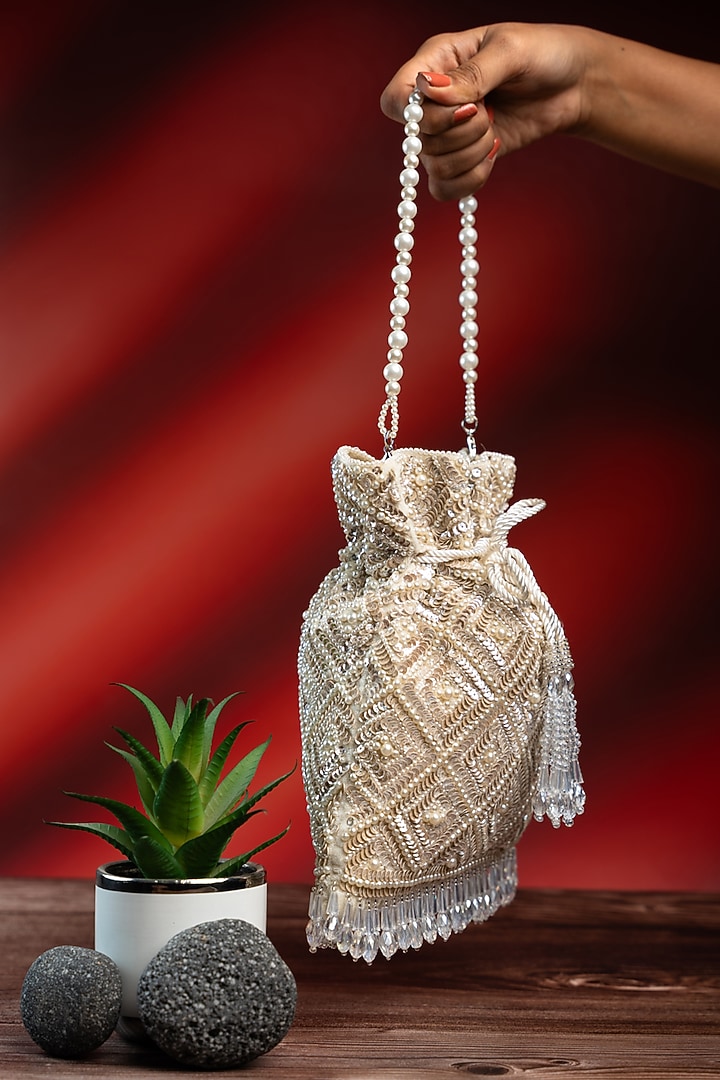 Off-White Silk Pearl Work Potli by Nayaab by Sonia at Pernia's Pop Up Shop