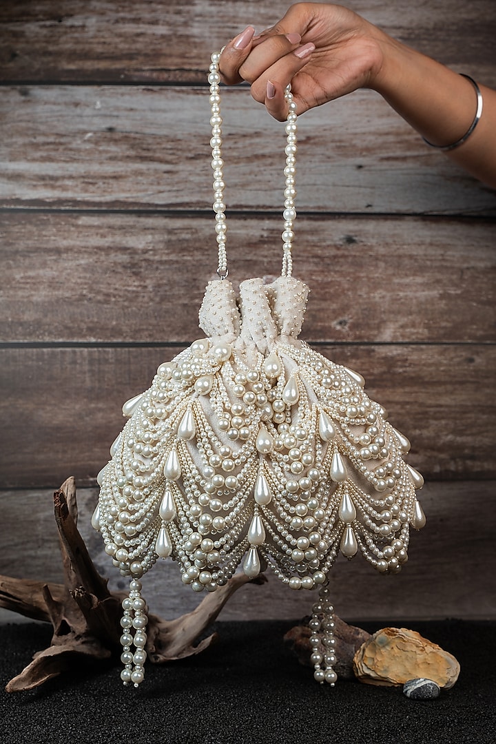 Ivory Velvet Embroidered Potli by Nayaab by Sonia at Pernia's Pop Up Shop