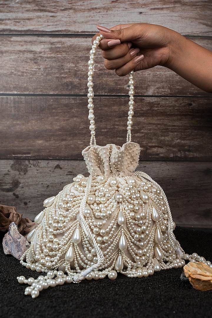 Ivory Velvet Embroidered Potli by Nayaab by Sonia at Pernia's Pop Up Shop