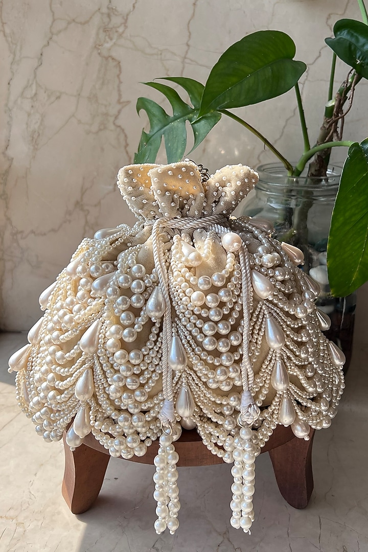 Ivory Velvet Embroidered Potli by Nayaab by Sonia at Pernia's Pop Up Shop