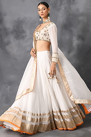 Ivory Lehenga Set With Gold Finishing by Neha Chopra Tandon