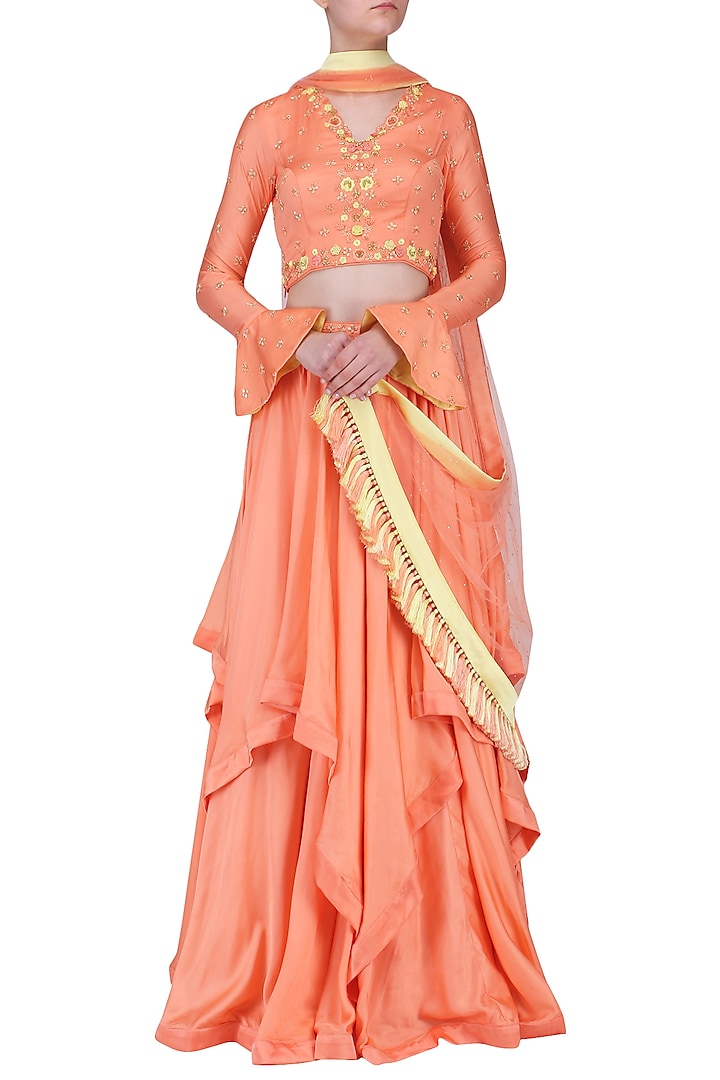 Peach embroidered layered lehenga set available only at Pernia's Pop Up Shop.
