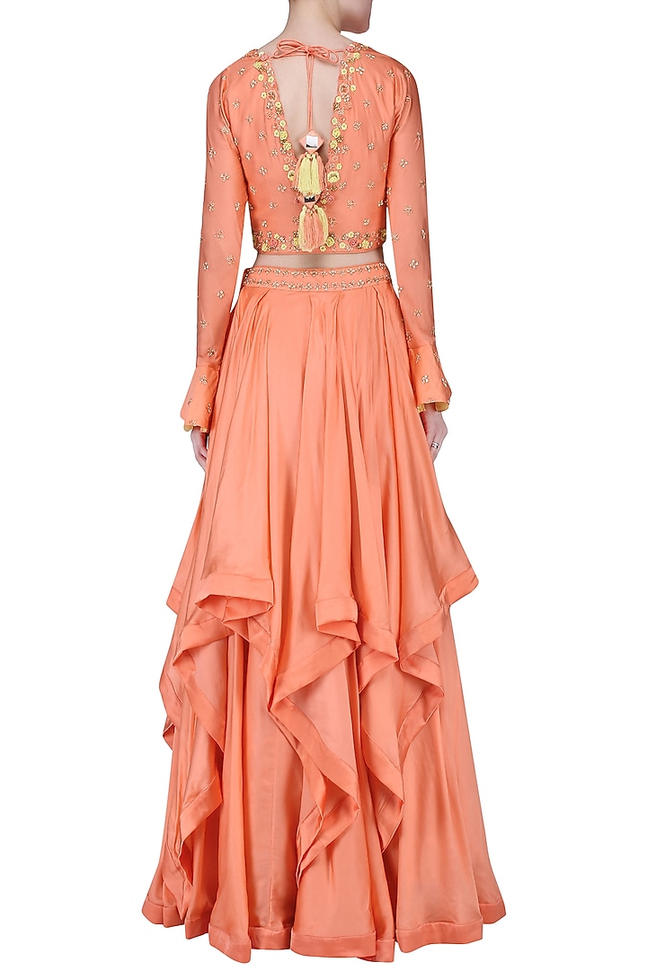 Peach embroidered layered lehenga set available only at Pernia's Pop Up Shop.