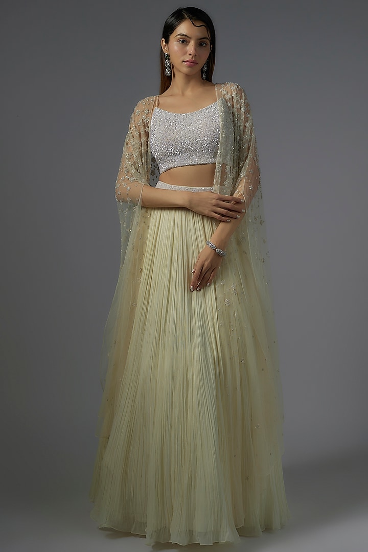 Ivory Net & Viscose Motif Embroidered Jacket Lehenga Set by COUTURE BY NIHARIKA