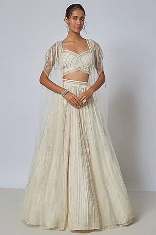 Ivory Net Sequins Embroidered Lehenga Set by COUTURE BY NIHARIKA
