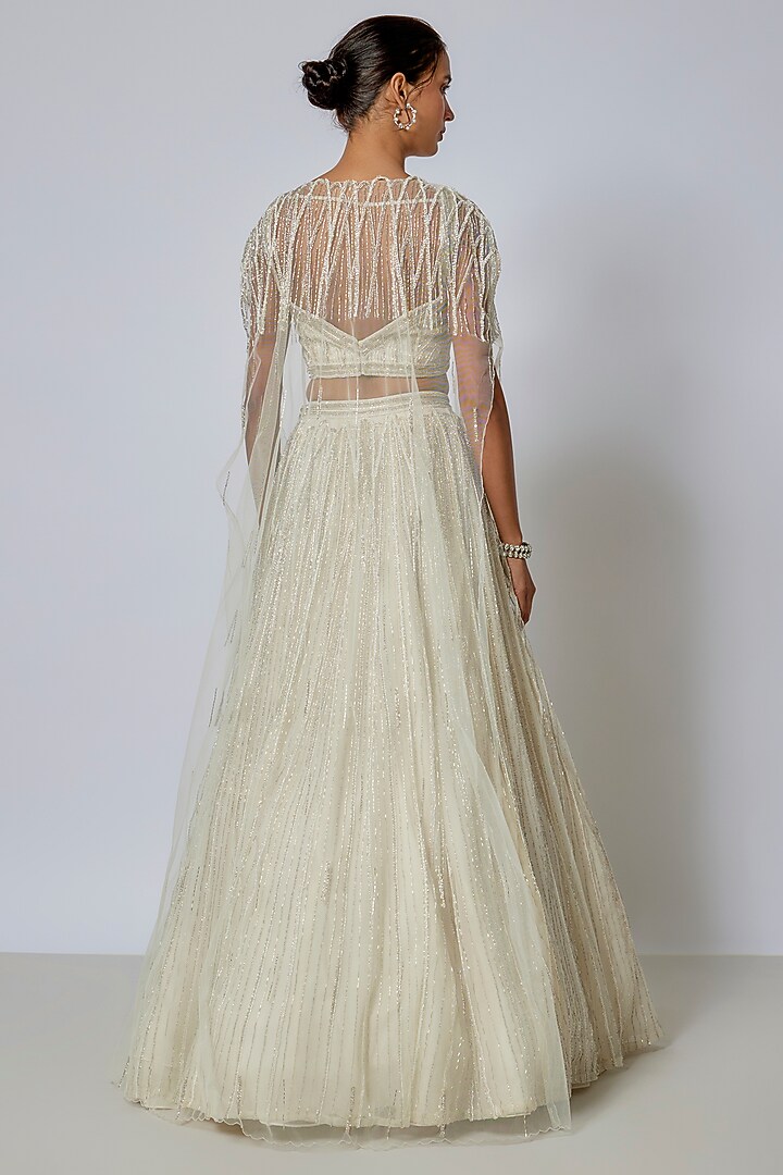 Ivory Net Sequins Embroidered Wedding Lehenga Set by COUTURE BY NIHARIKA at Pernia's Pop Up Shop