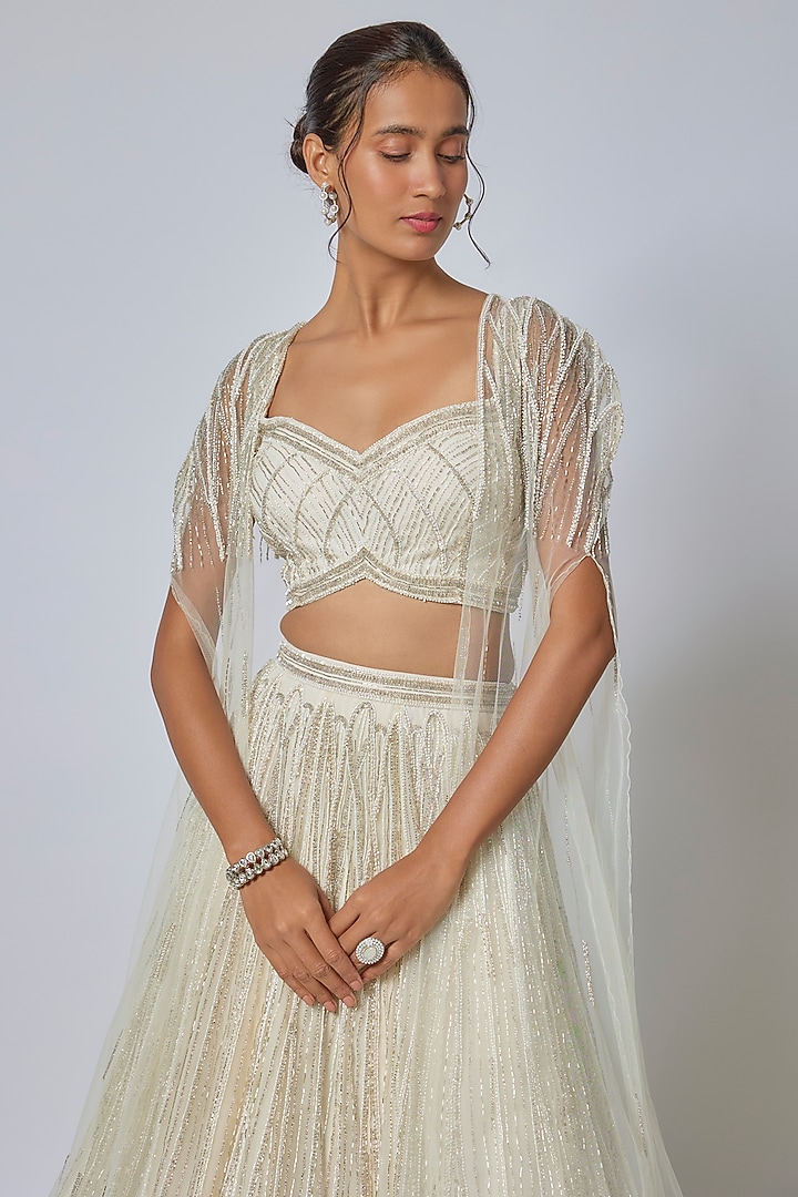 Ivory Net Sequins Embroidered Wedding Lehenga Set by COUTURE BY NIHARIKA at Pernia's Pop Up Shop