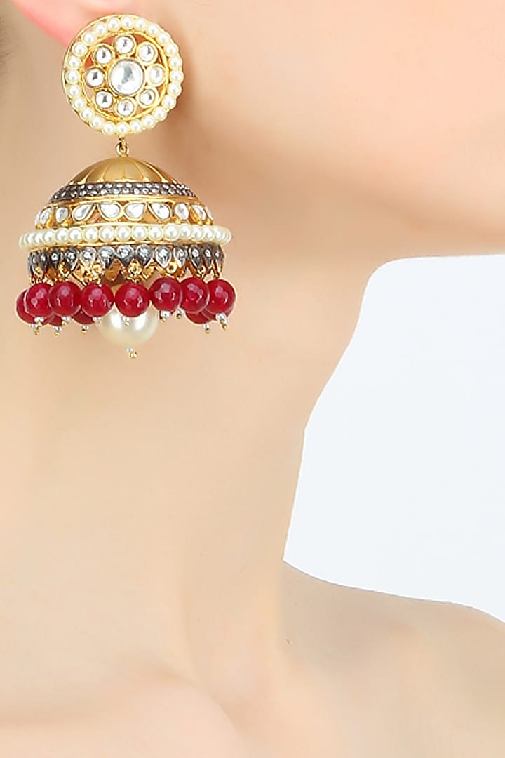 Gold plated kundan and ruby jhumki earrings by Nepra By Neha Goel