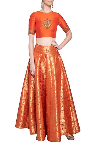 Orange embroidered crop top with lehenga skirt by Ranian