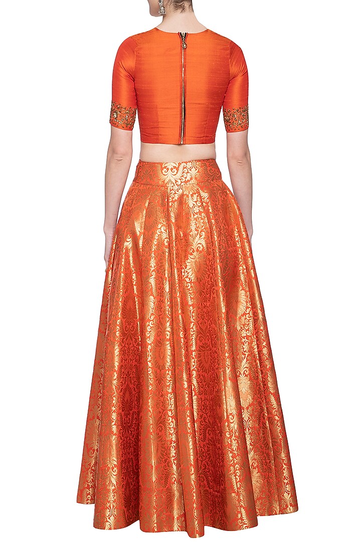 Orange embroidered crop top with lehenga skirt by Ranian at Pernia's Pop Up Shop