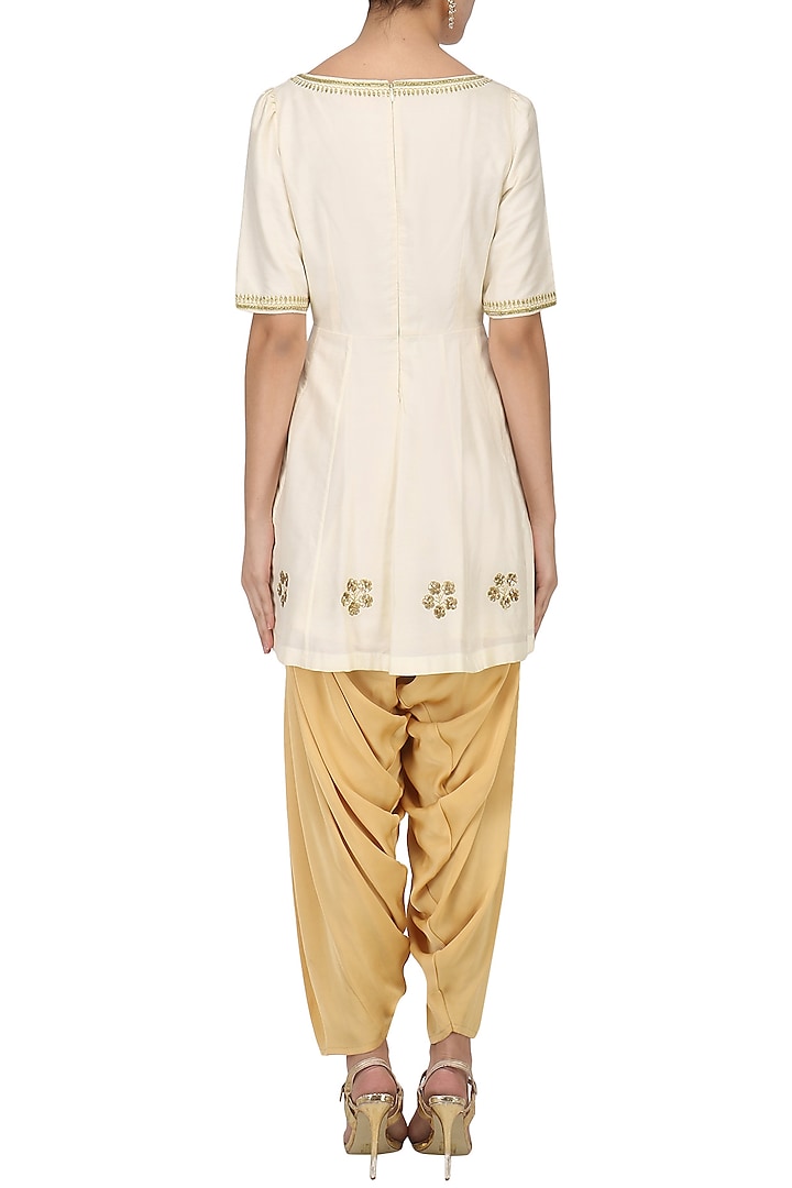 Ivory embroidered peplum kurta with dhoti salwar set available only at Pernia's Pop Up Shop.