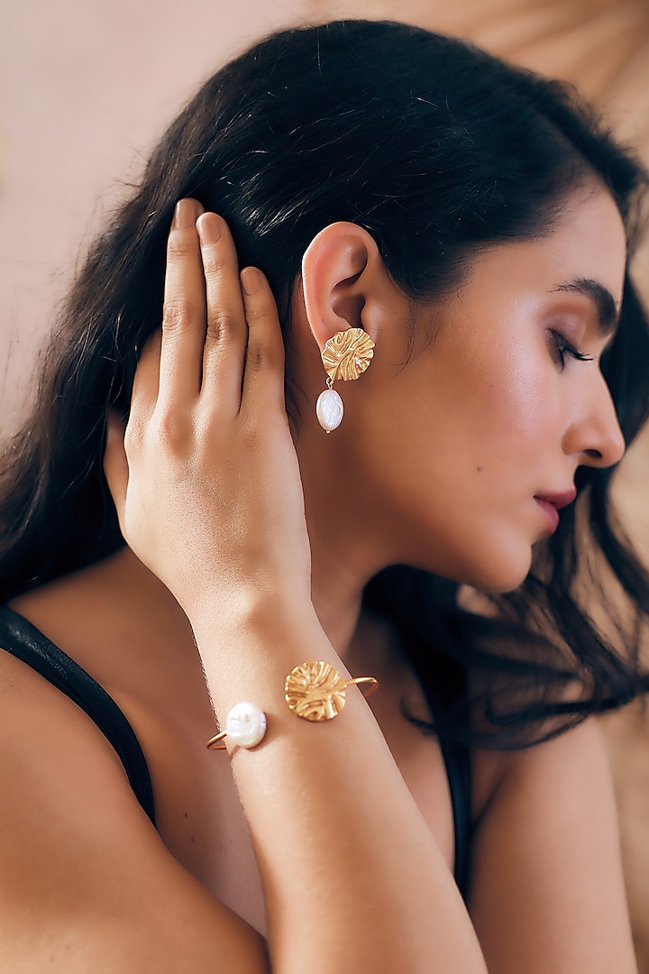 Gold Finish Pearl Handcrafted Dangler Earrings With Cuff by NIHIRAA INDIA at Pernia's Pop Up Shop