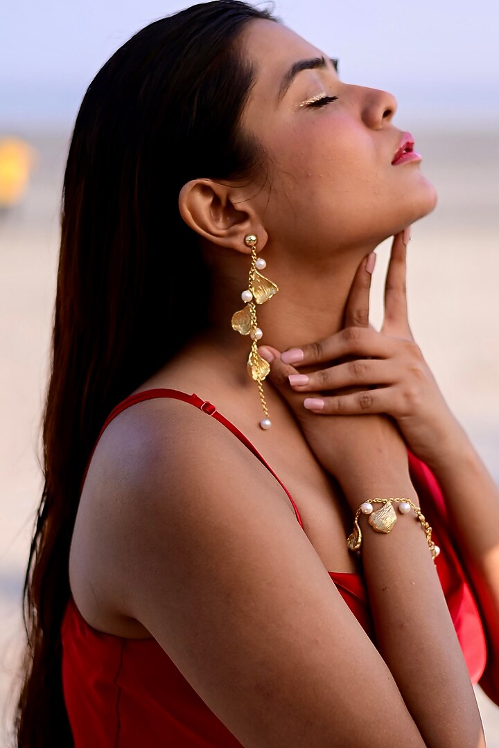 Gold Finish Pearl Handcrafted Dangler Earrings With Bracelet by NIHIRAA INDIA at Pernia's Pop Up Shop