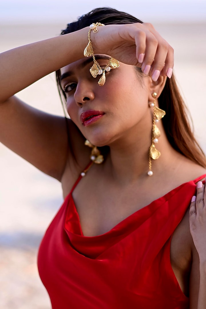 Gold Finish Pearl Handcrafted Dangler Earrings With Bracelet by NIHIRAA INDIA at Pernia's Pop Up Shop