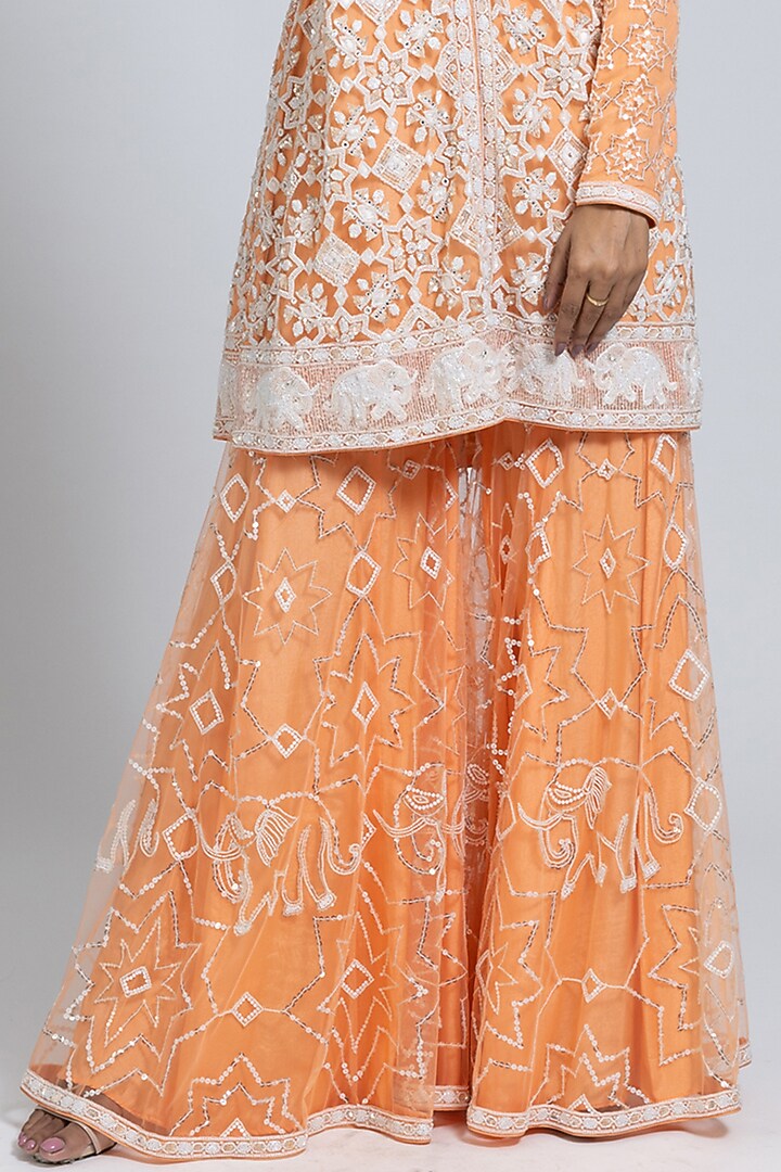 Peach Net Moti & Cutdana Hand Embellished Flared Bridal Sharara Set by NIMA FASHIONS at Pernia's Pop Up Shop