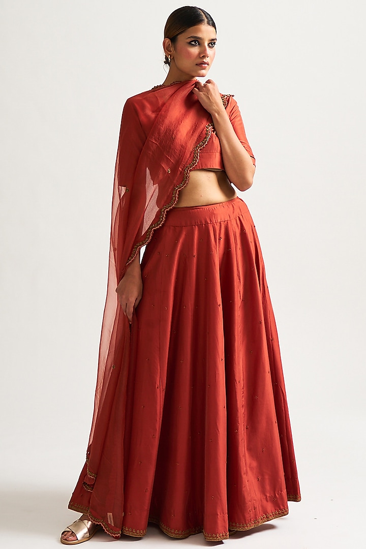 Rust Hand Embroidered Lehenga Set by Nishar Ahmed