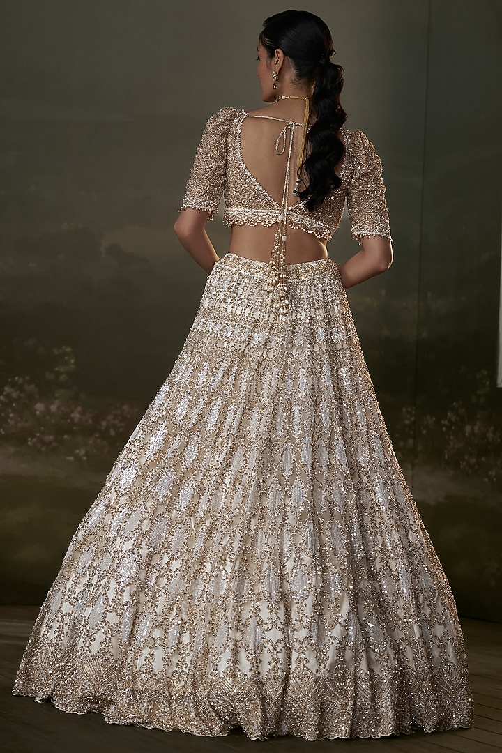 Ivory Net & Satin Sequins Embroidered Bridal Lehenga Set by NITIKA GUJRAL at Pernia's Pop Up Shop