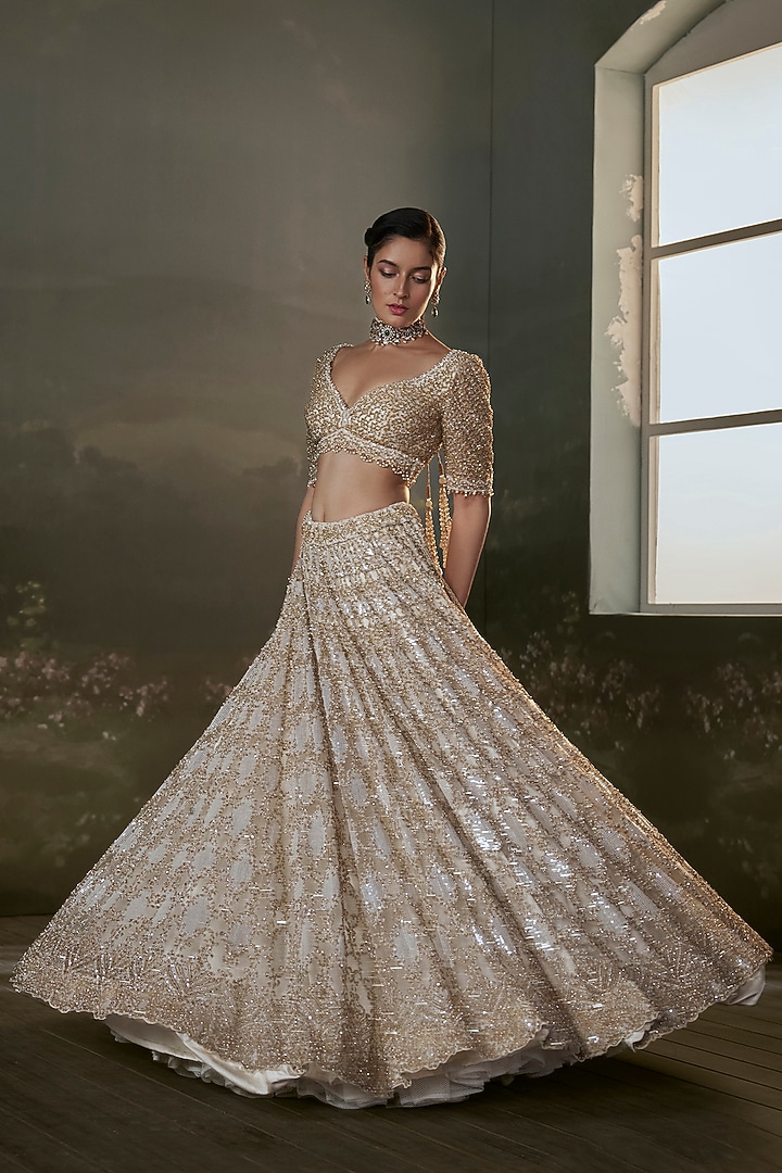 Ivory Net & Satin Sequins Embroidered Bridal Lehenga Set by NITIKA GUJRAL at Pernia's Pop Up Shop