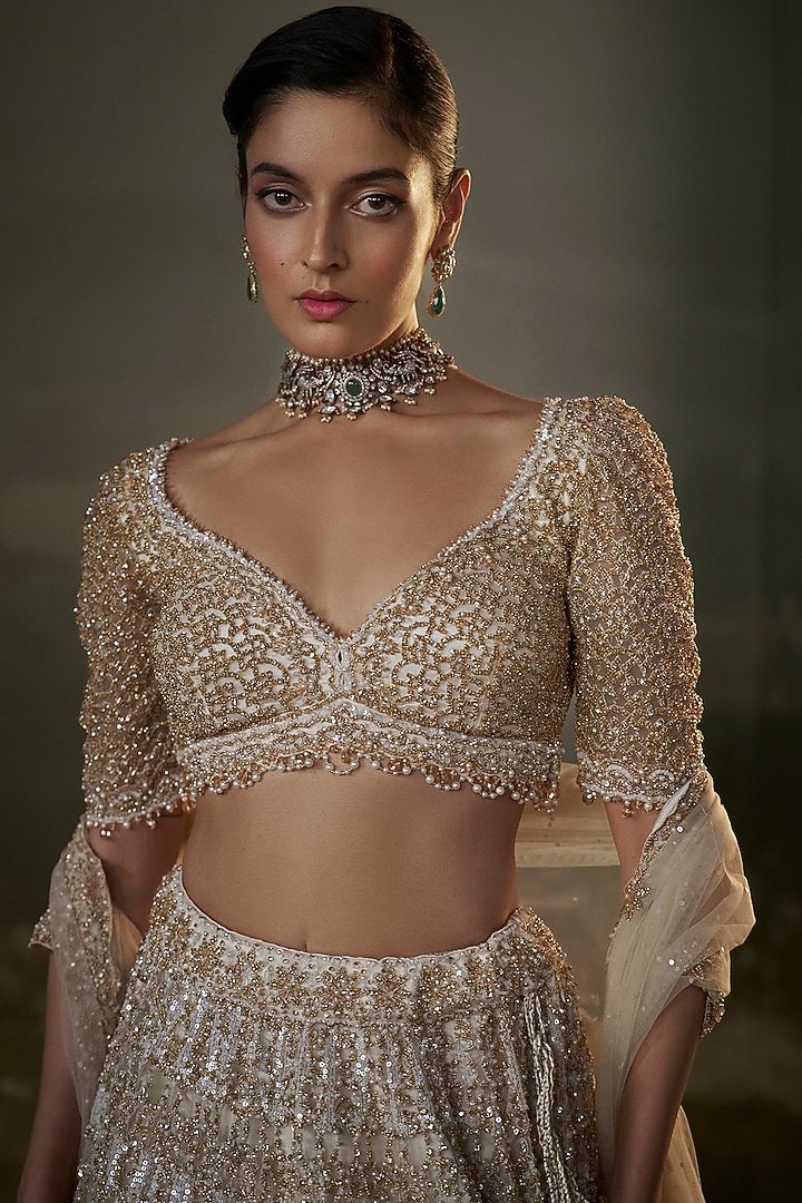 Ivory Net & Satin Sequins Embroidered Bridal Lehenga Set by NITIKA GUJRAL at Pernia's Pop Up Shop