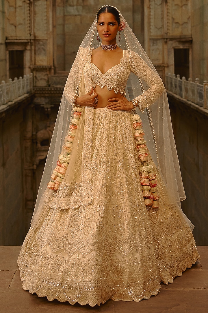 Ivory Net Cutdana Embroidered Bridal Lehenga Set by NITIKA GUJRAL at Pernia's Pop Up Shop
