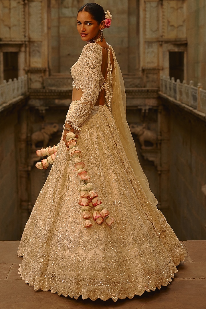 Ivory Net Cutdana Embroidered Bridal Lehenga Set by NITIKA GUJRAL at Pernia's Pop Up Shop