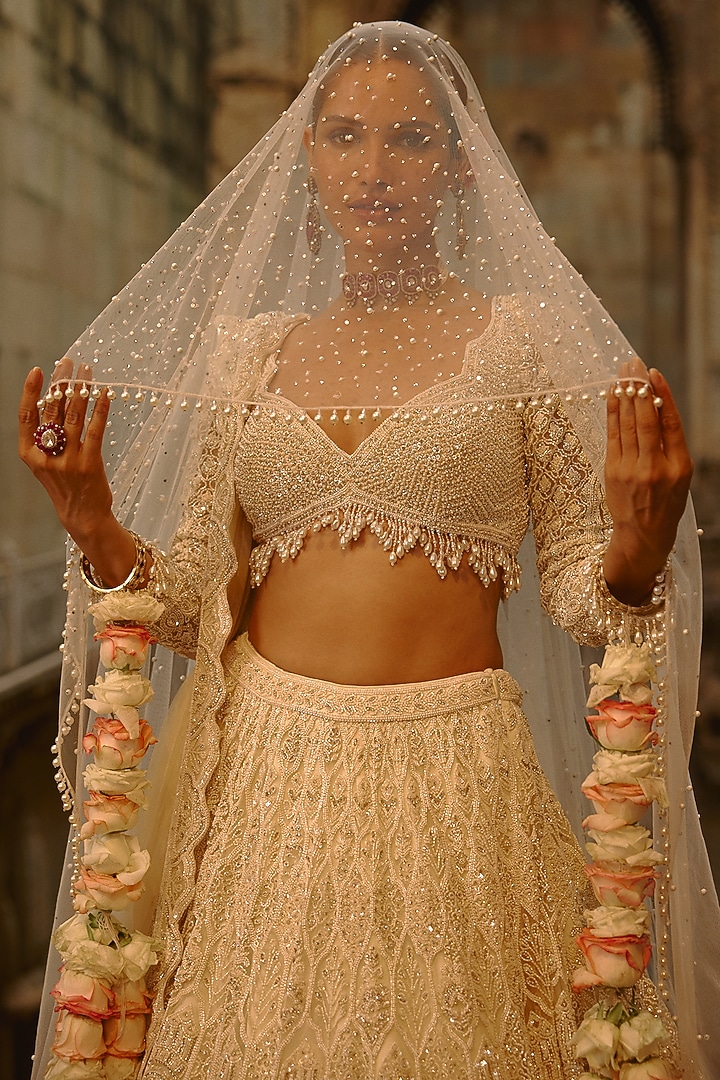 Ivory Net Cutdana Embroidered Bridal Lehenga Set by NITIKA GUJRAL at Pernia's Pop Up Shop