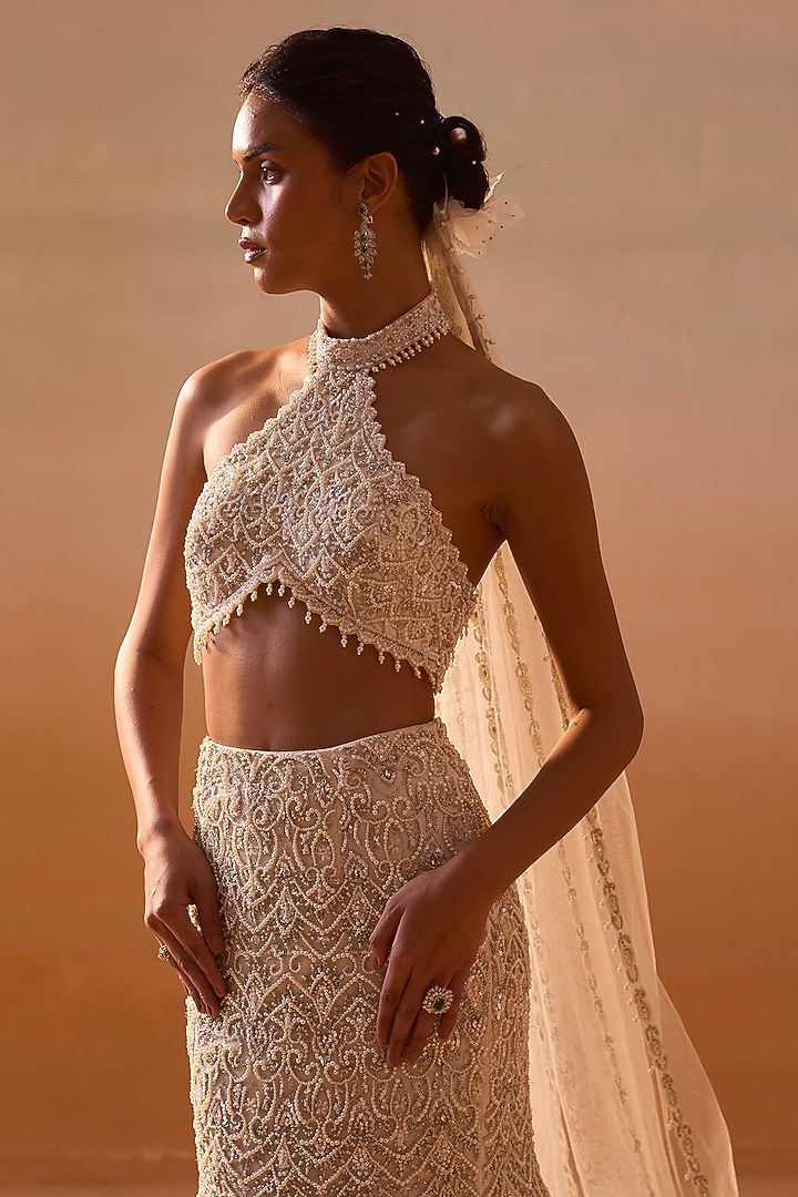 Ivory Net Crystal & Pearl Embellished Fishtail Skirt Set by NITIKA GUJRAL at Pernia's Pop Up Shop