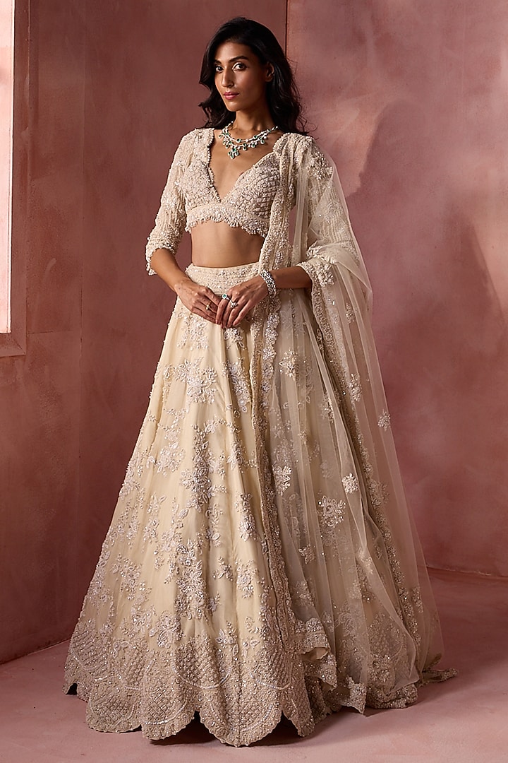 Ivory Net & Satin Floral Embroidered Bridal Lehenga Set by NITIKA GUJRAL at Pernia's Pop Up Shop