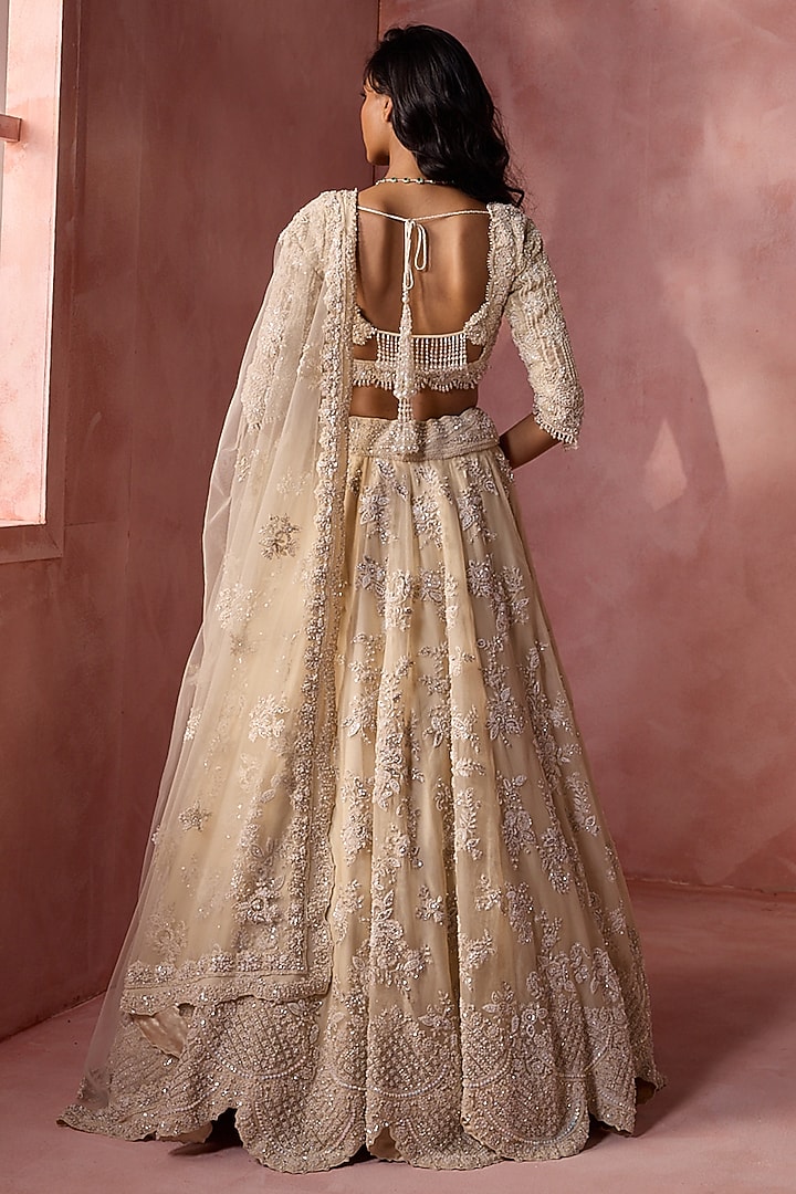 Ivory Net & Satin Floral Embroidered Bridal Lehenga Set by NITIKA GUJRAL at Pernia's Pop Up Shop