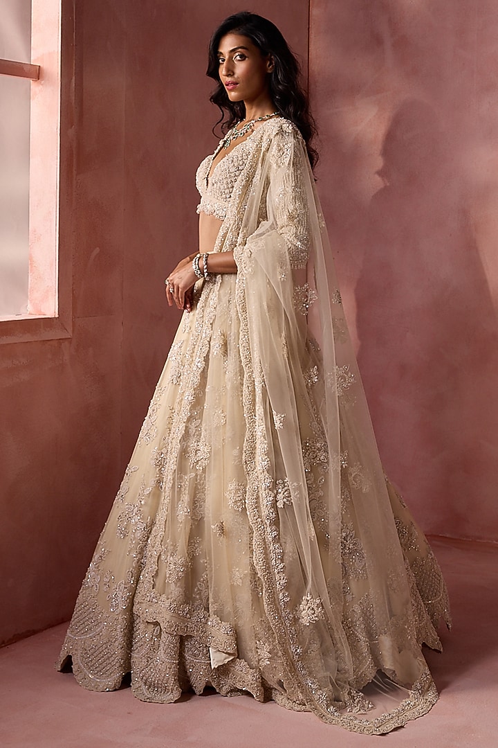 Ivory Net & Satin Floral Embroidered Bridal Lehenga Set by NITIKA GUJRAL at Pernia's Pop Up Shop