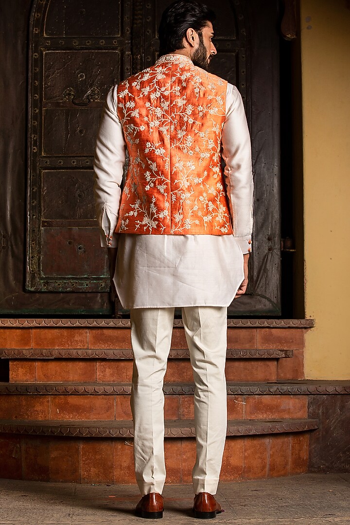 Orange Raw Silk Mirror Embroidered Bundi Jacket Set by NITIKA GUJRAL MEN at Pernia's Pop Up Shop