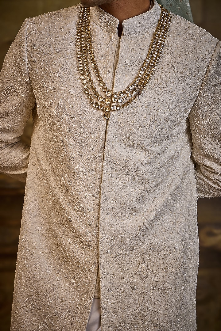 Ivory Raw Silk & Cotton Silk Cutdana Embroidered Groom Sherwani Set by NITIKA GUJRAL MEN at Pernia's Pop Up Shop