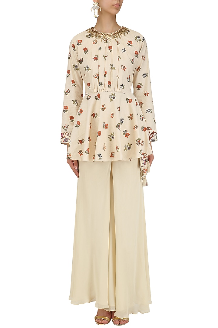 Cream embroidered peplum top and pants set