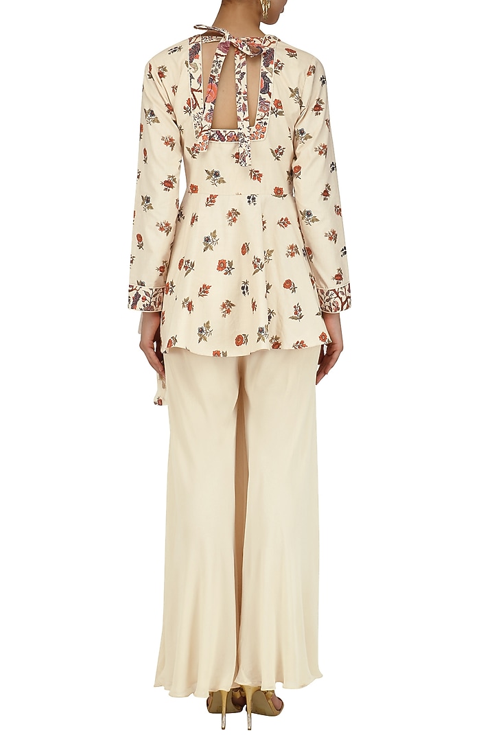 Cream embroidered peplum top and pants set