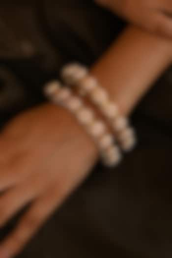 Micro Gold Finish Kundan Polki & Pearl Bangles (Set Of 2) by Namasya at Pernia's Pop Up Shop