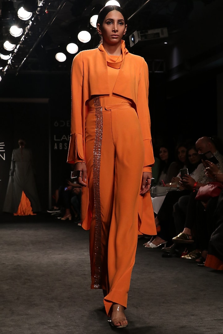 Tangerine high low coat with turtle neck body suit and bell bottom pants available only at Pernia's Pop Up Shop.