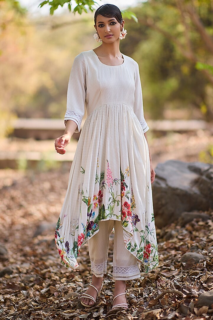 Ivory Mul Silk Floral Printed & Hand Embroidered Asymmetrical Kurta Set by Nirmooha at Pernia's Pop Up Shop