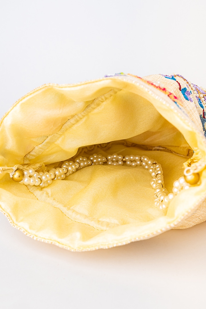 Cream & Purple Raw Silk Embroidered Potli by NR By Nidhi Rathi at Pernia's Pop Up Shop