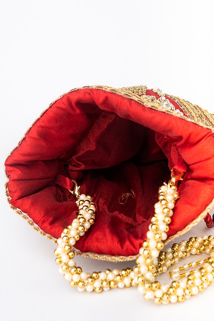 Maroon & Gold Raw Silk Embroidered Potli by NR By Nidhi Rathi at Pernia's Pop Up Shop