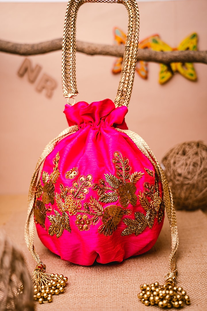 Pink & Gold Raw Silk Embroidered Potli by NR By Nidhi Rathi at Pernia's Pop Up Shop