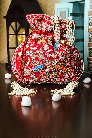 Red Raw Silk Hand Embroidered Potli by NR By Nidhi Rathi