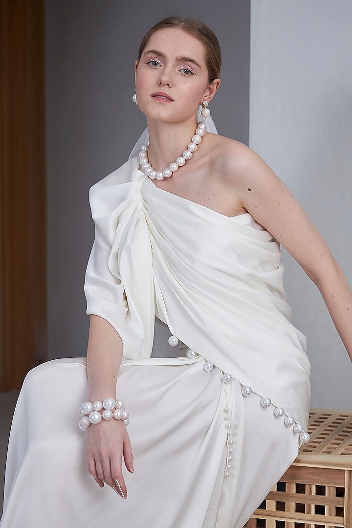 White Satin Silk Pearl Embellished One-Shoulder Gown by Naina Seth at Pernia's Pop Up Shop