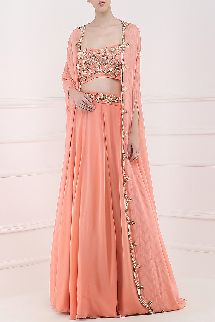 Coral embroidered lehenga, crop top and cape set available only at Pernia's Pop Up Shop.