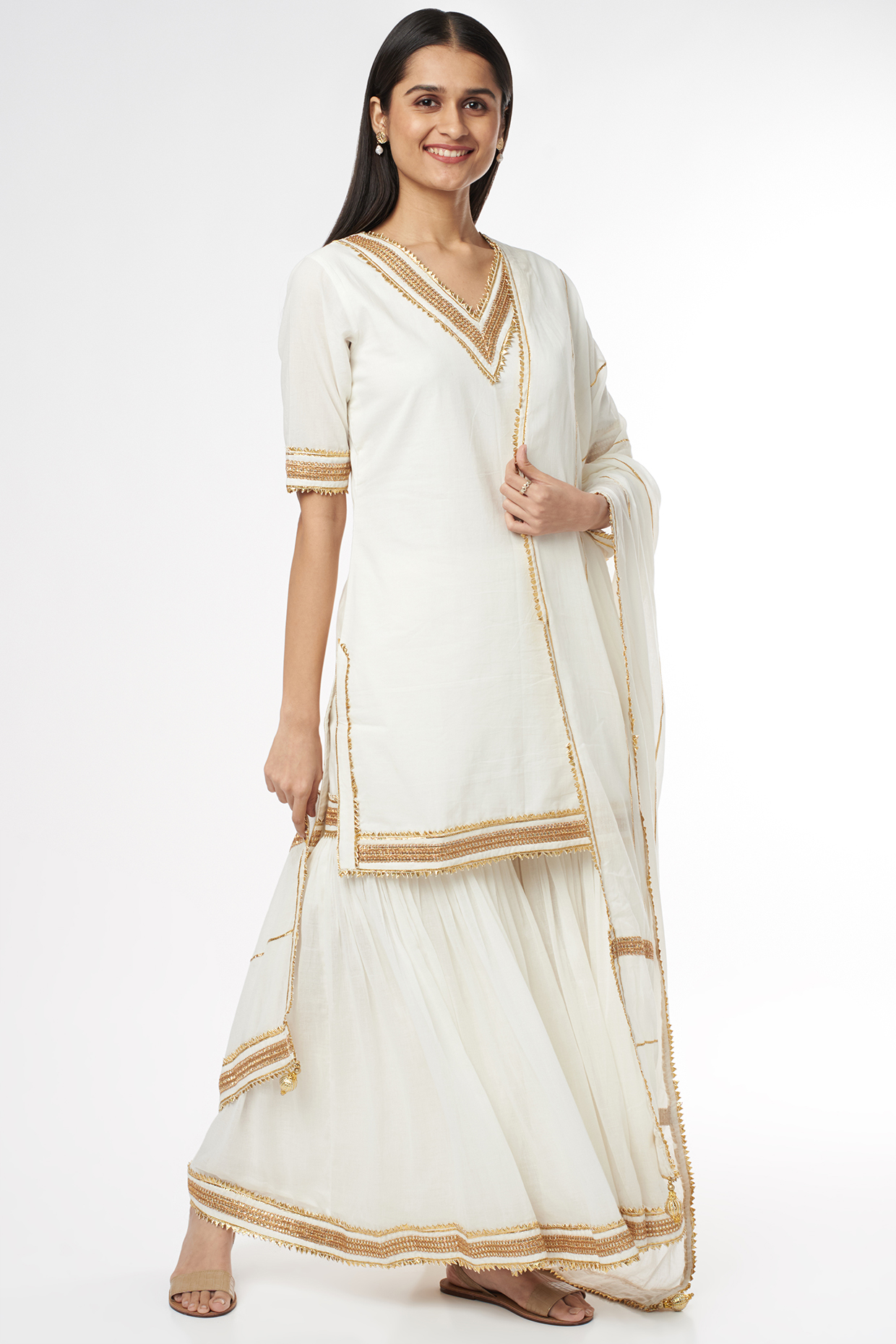 White Mulmul Tiered Sharara Set by Omaana Jaipure at Pernia's Pop Up Shop