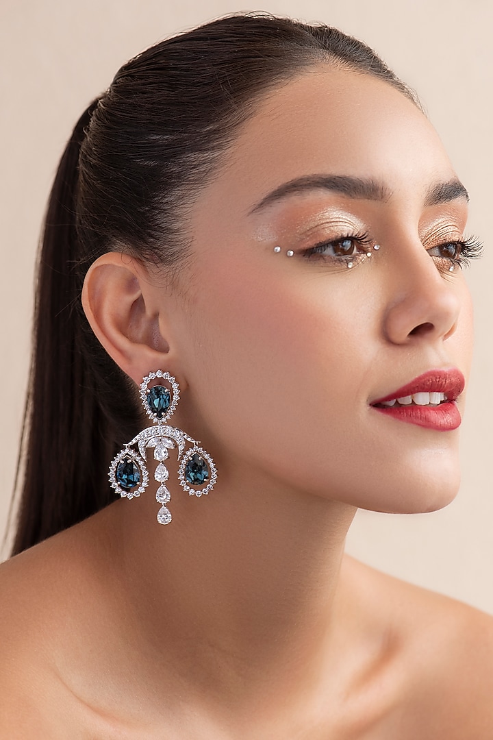 White Finish Blue Swarovski Dangler Earrings In Sterling Silver by Opalina at Pernia's Pop Up Shop