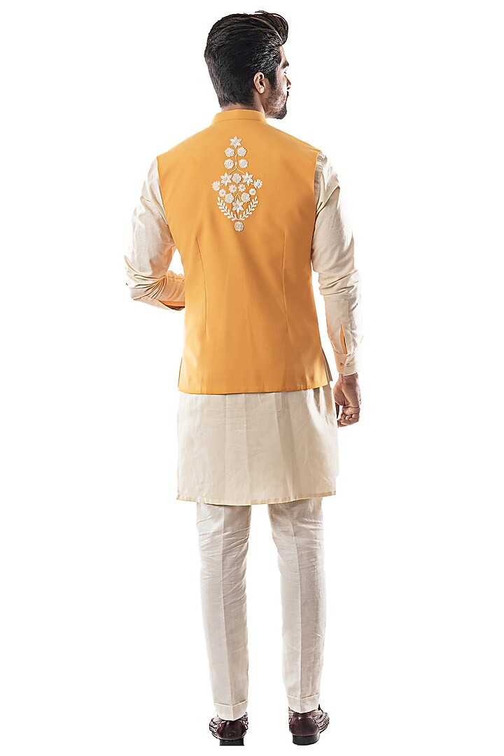 Mustard Terry Cotton Motif Embroidered Asymmetric Bundi Jacket by PAARSH at Pernia's Pop Up Shop